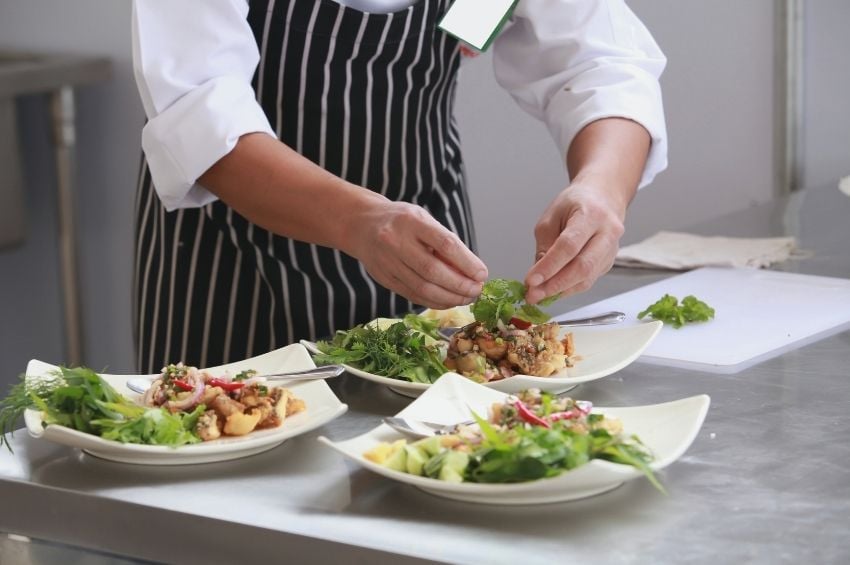 Food handler preparing food away from allergy-safe preparation spaces