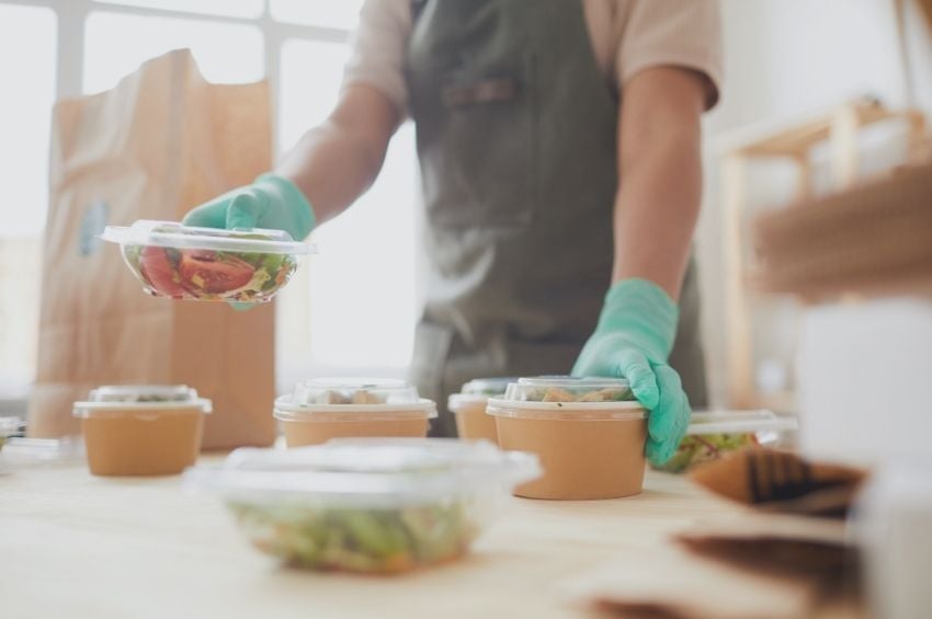 Food handler separating foods and wearing gloves to prevent a food safety fail