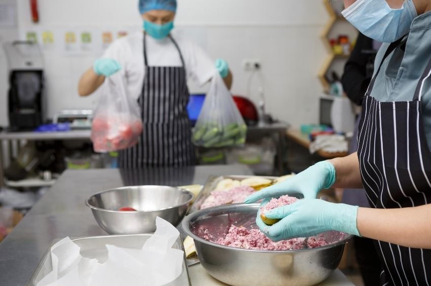 Food handlers practicing food safety to prevent contamination