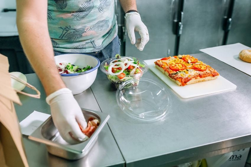 Food handler using gloves to help prevent customers from having an allergic reaction to their food