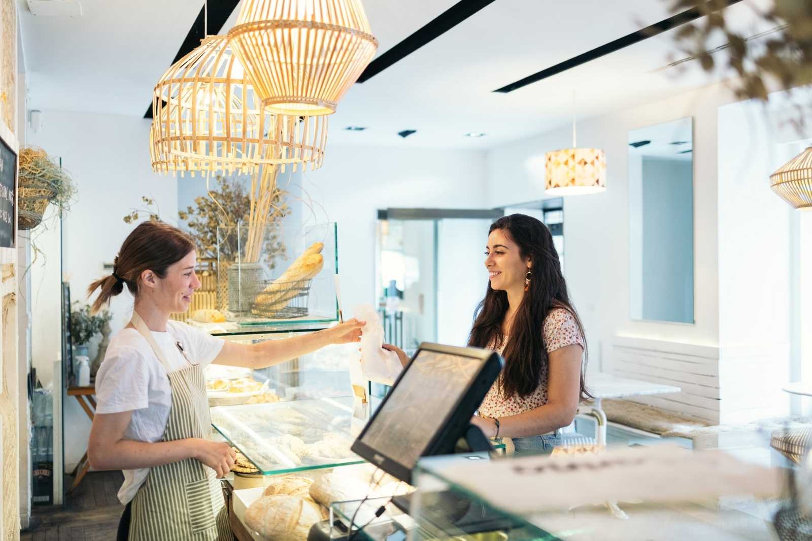 Foodservice worker handing a customer their order