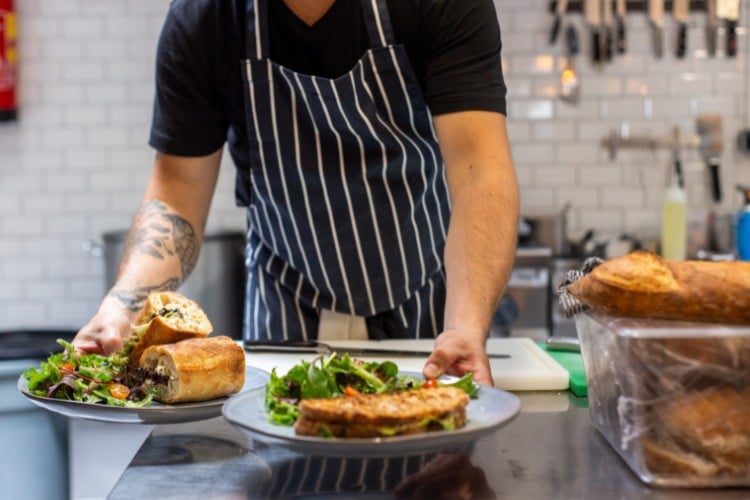 Food handler safely multitasking at a restaurant