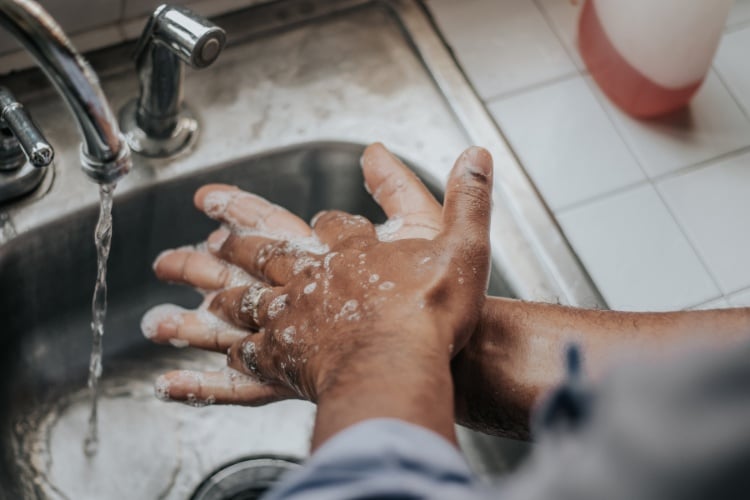 Food handler washing their hands to maintain good personal hygiene