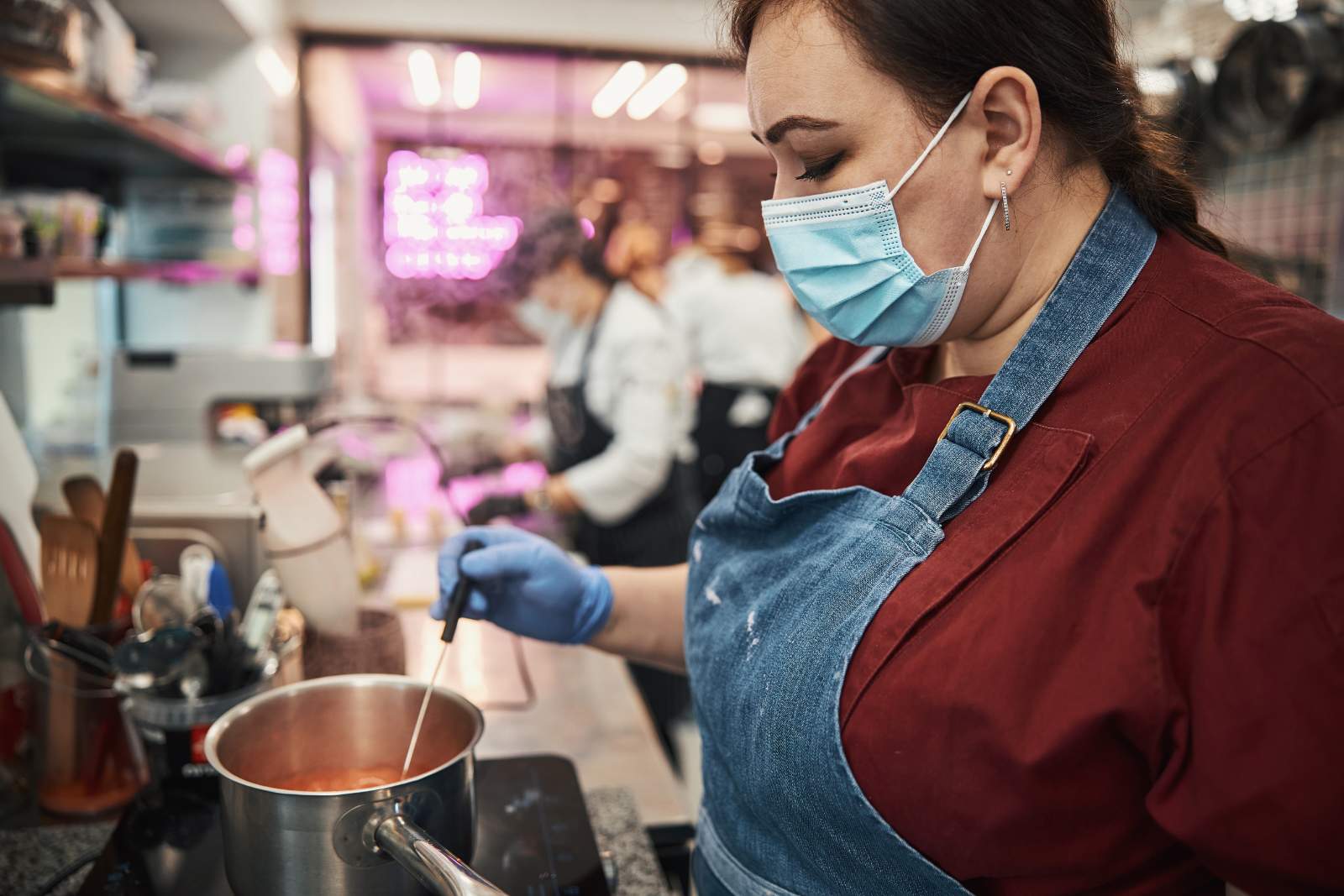 Woman testing a sauce for safety